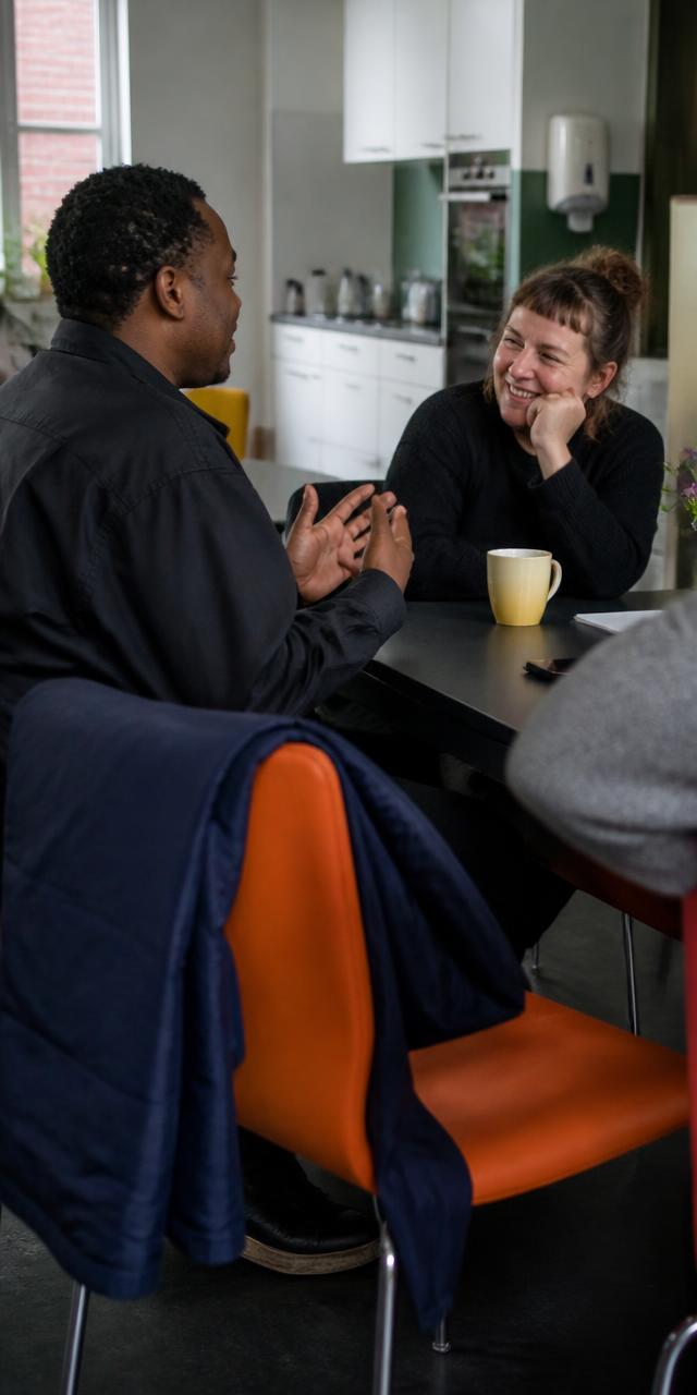 Two people in conversation across a table