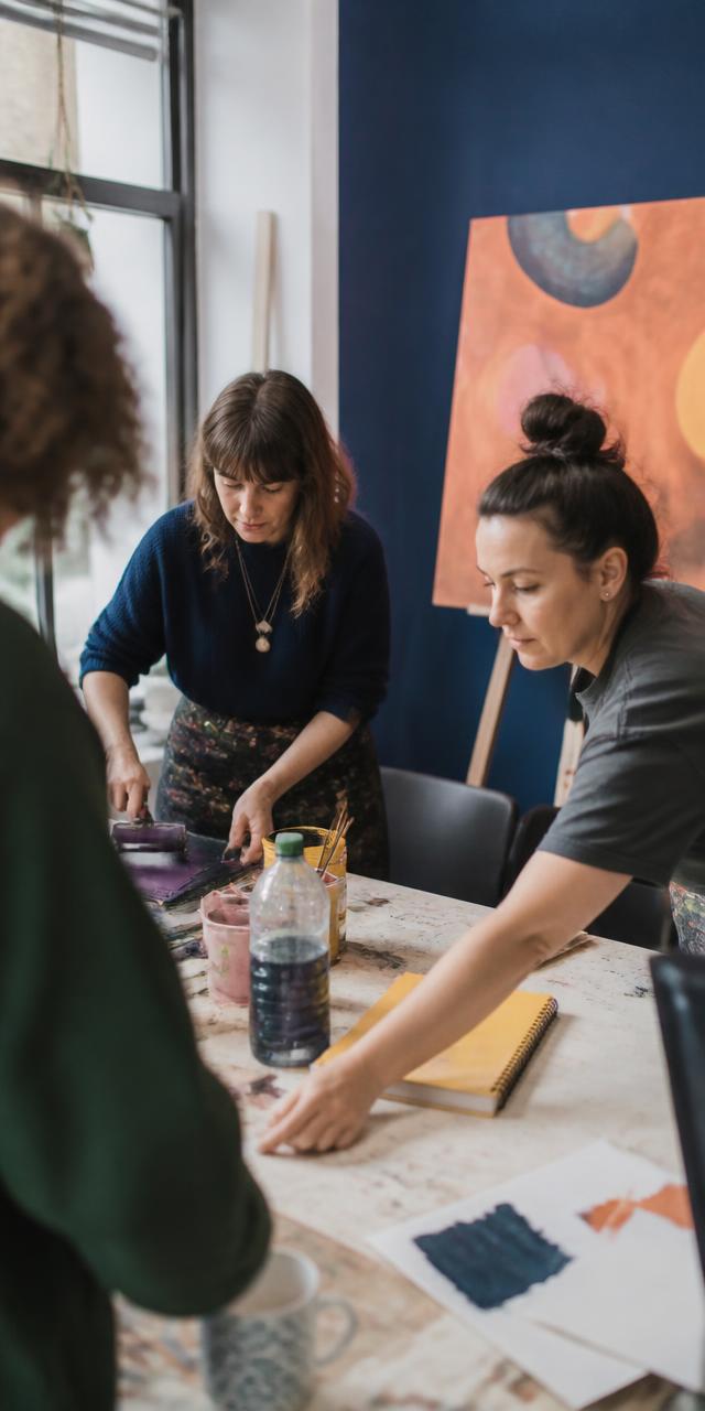 People printing and making things together in a bright studio